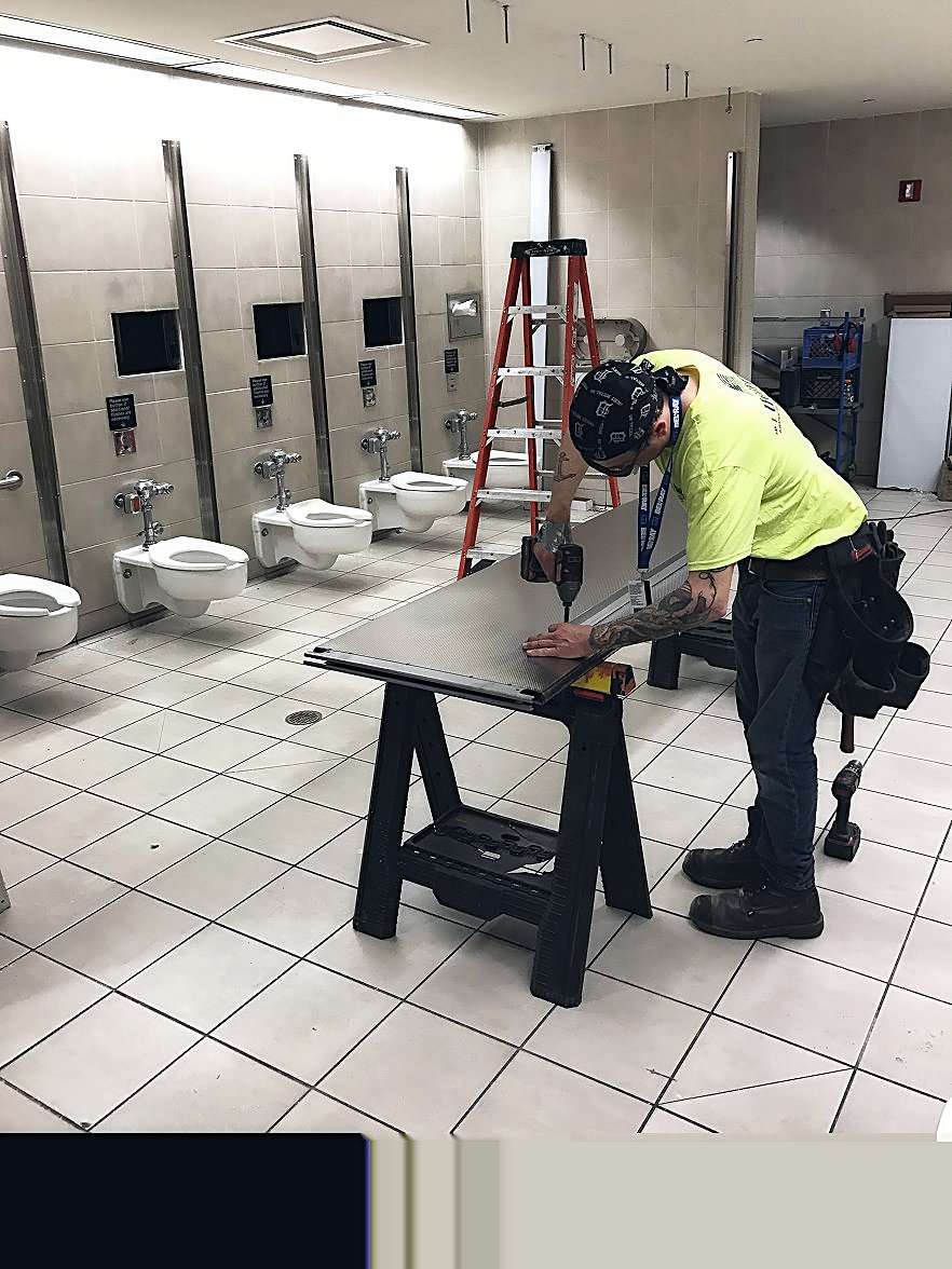 RELCO tradesman fabricating a partition panel on site