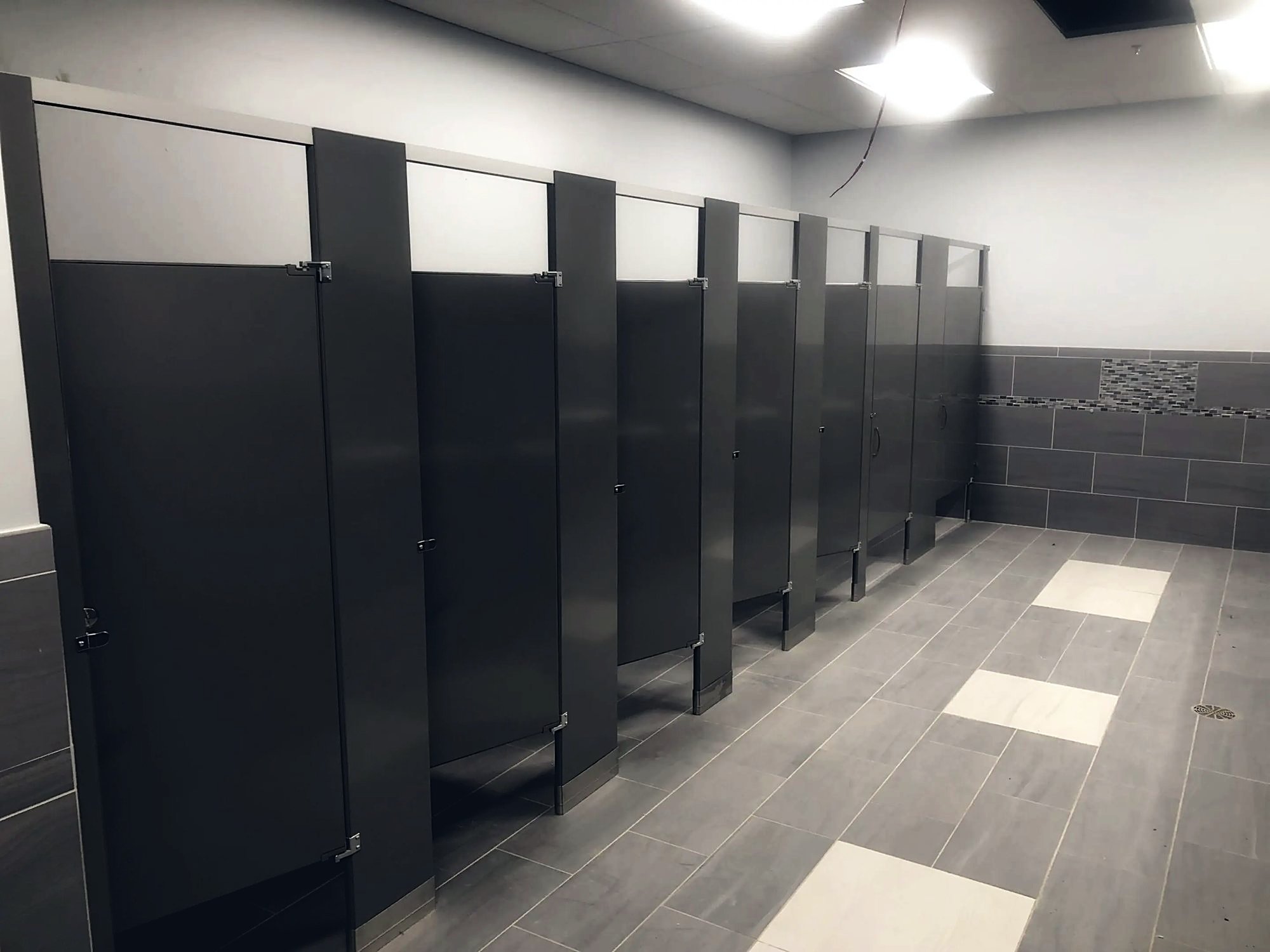 Toilet partitions installed in a modern commercial restroom