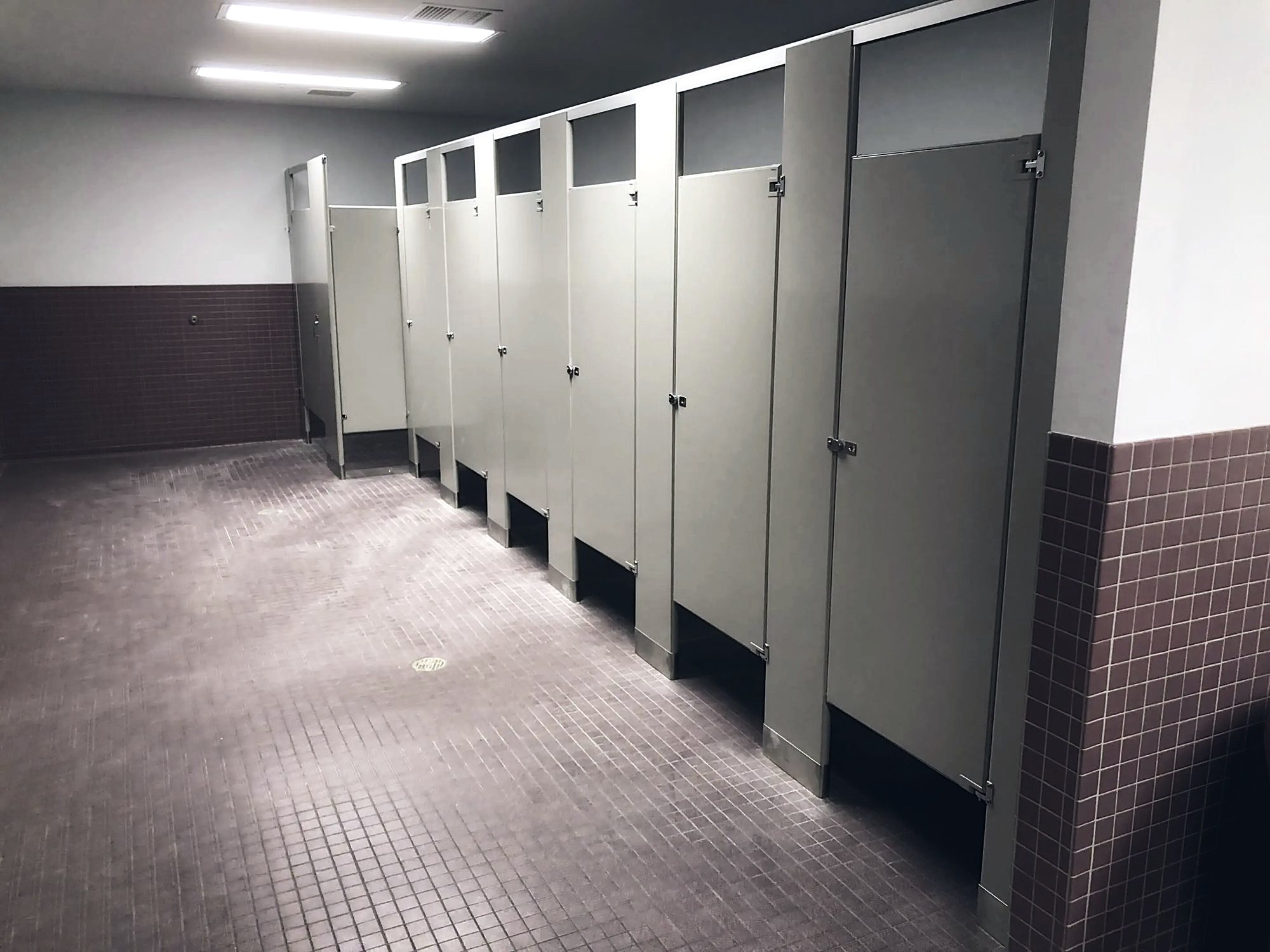 Toilet partitions with ceramic tile wainscot